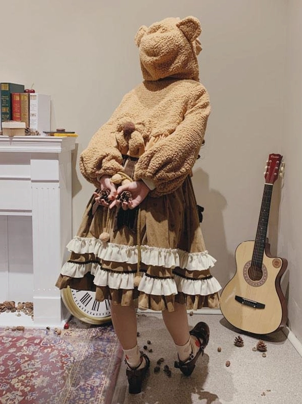 Sweet lolita bear ear fuzzy coat back view faceless model showing hood design layered ruffle skirt holding pinecones autumn aesthetic