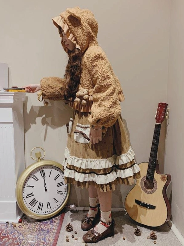 Sweet lolita bear ear hooded fuzzy coat side profile full body shot coffee brown sherpa with layered ruffle skirt fireplace prop