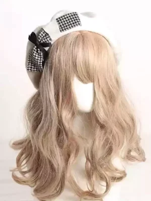 Sweet Lolita beret with houndstooth patches and black satin bow displayed on mannequin, front three-quarter view, white beret base with classic color-block design