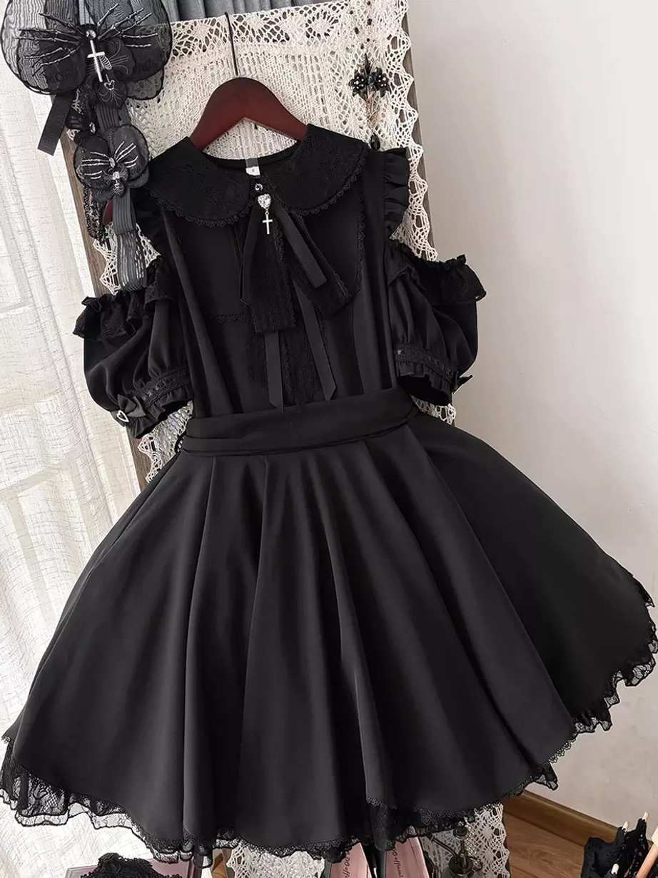 Black sweet lolita dress hanging display front view showing peter pan collar cold-shoulder puff sleeves lace skirt hem and attached bow decoration indoor home display