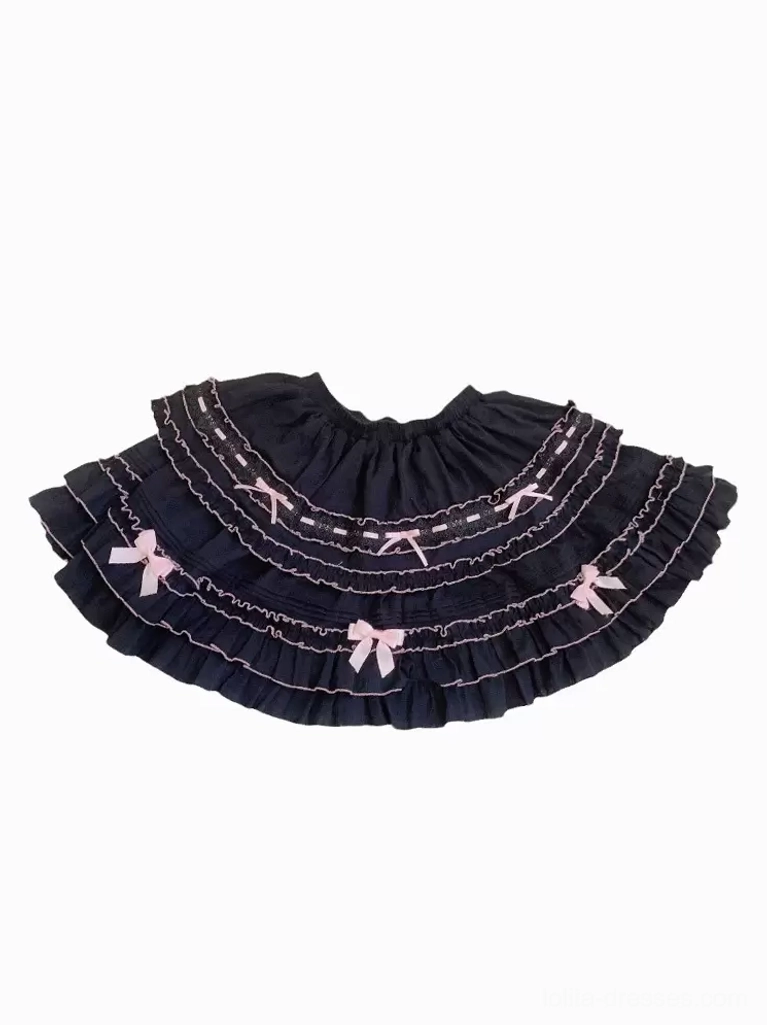 Black Lolita ruffled skirt with white ruffled trims light pink bows elastic waistband flat lay on white background