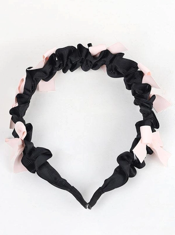 Sweet lolita black bow headband flat lay overhead view circular design light pink bows on white background