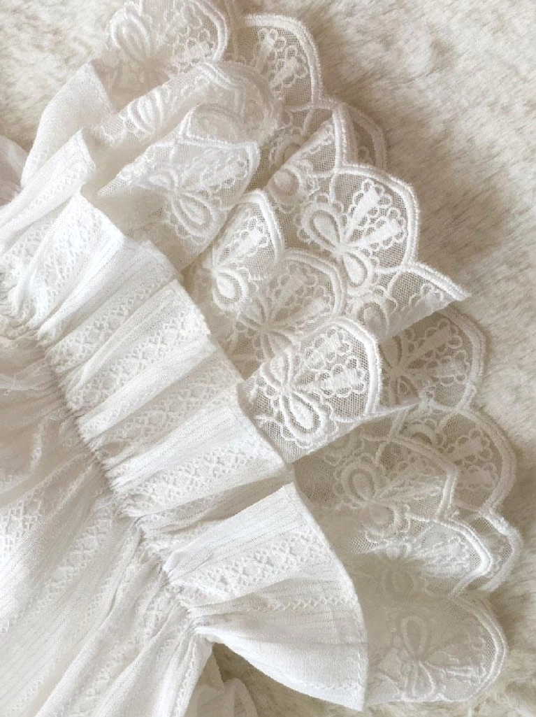Floral embroidered lace trim with scalloped curved edges on sweet lolita bloomers extreme close-up