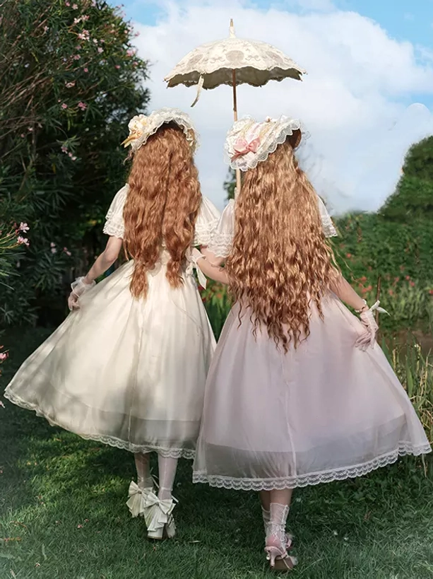 Back view of Sweet Lolita bonnet headdress with curly long hair, matching lace parasol and garden lawn setting showing complete aesthetic