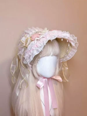 Sweet lolita bonnet headdress with pink ruffled lace and artificial flowers worn on mannequin, left front three-quarter angle view showing pearl ornaments and pink chin ribbons