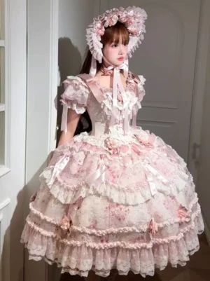 Pink sweet lolita bonnet paired with matching floral dress and puffed sleeves on real female model, full-body front shot demonstrating complete coordinate styling with layered ruffled skirt and three-dimensional flower details