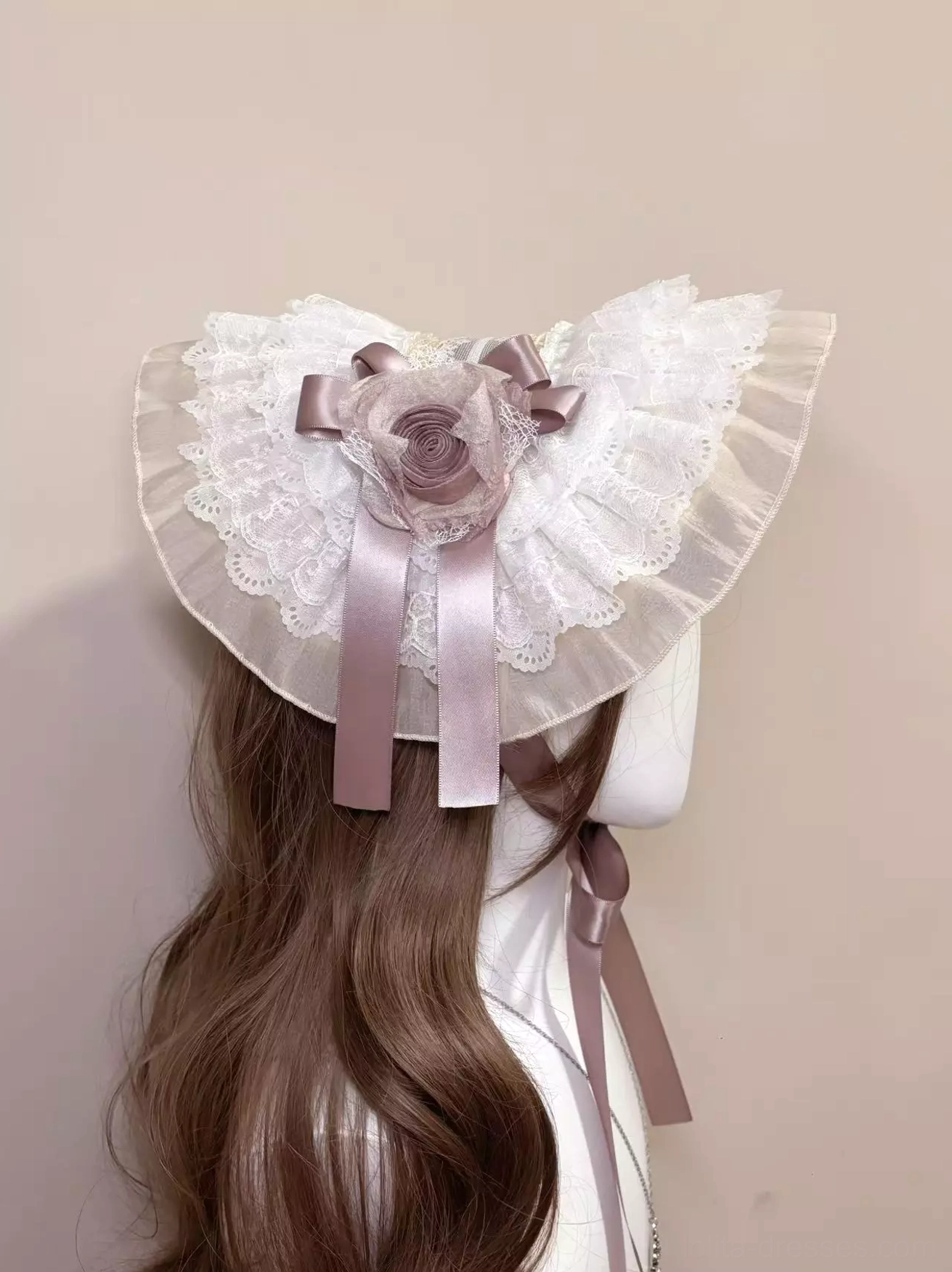 Lolita bonnet rear top-down display showing symmetrical ruffled white lace, mauve satin ribbon ties, and complete bonnet silhouette on mannequin with long wavy brown hair