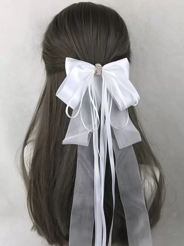 Sweet lolita bow hair clip styling guide showing how to wear satin bow with ribbon streamers as coordinated headwear accessory