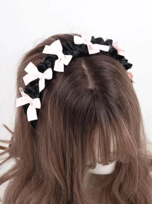 Sweet lolita bow headband rear central overhead view showing multiple pink bows placement on black satin band mannequin