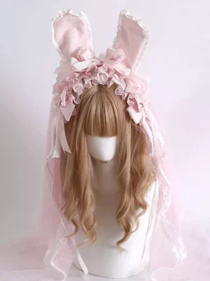 Sweet lolita bunny ear headband front view with pink tulle veil, white lace ruffled trim, satin bows, and embossed bunny ear details on mannequin with light brown curly bangs