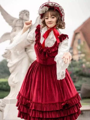 Sweet lolita burgundy JSK dress featuring ruffled bust design and full pleated skirt, sleeveless jumper photographed from high angle with model