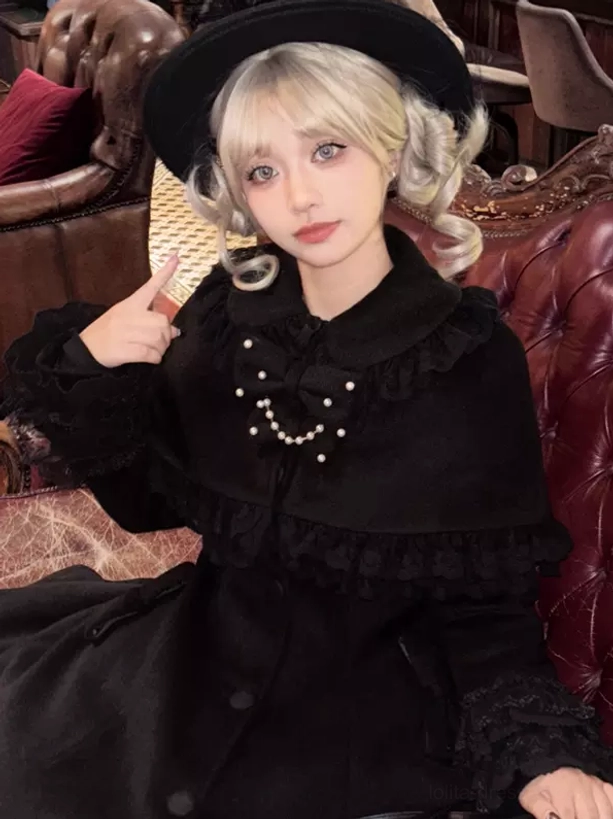 Sweet lolita cape coat detail shot showing removable lace cape construction ruffled edges and bow embellishments close-up view