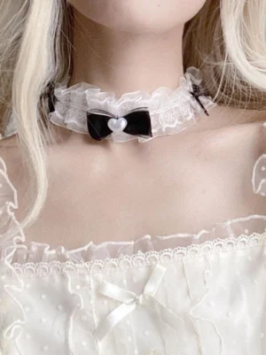 Sweet lolita white ruffled lace choker with black velvet bow and pearl heart charm worn on neck close-up front view