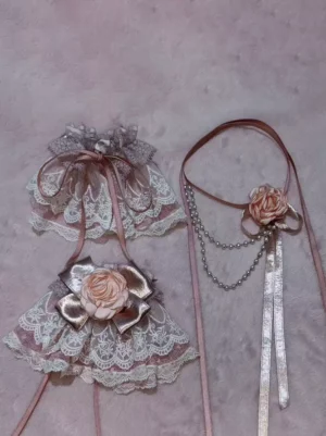 Sweet Lolita choker and wrist cuffs accessory set with pearl chains, 3D pink roses, and satin bows displayed on pink plush background - flat lay detail shot