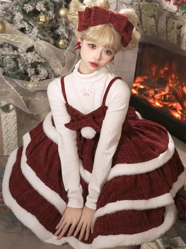 Christmas lolita slip dress with inner top featuring tiered ruffle skirt pompom bow accent and fireplace studio backdrop