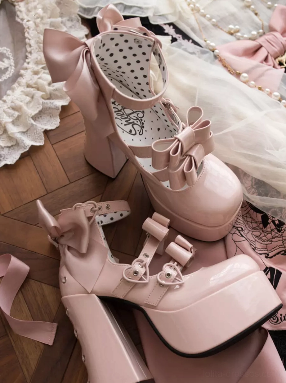 Sweet lolita chunky heel pumps with glossy finish showing Mary Jane style ankle straps, front and back bow details on elegant pink satin display