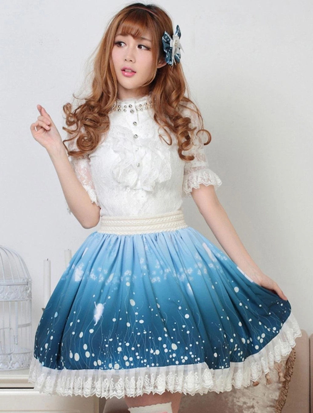 Three-quarter front view of sweet lolita coordinate featuring gradient blue ombre SK skirt with lace-trimmed blouse and hair clip accessory