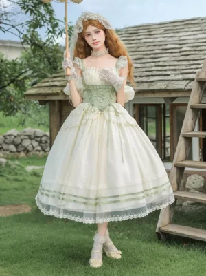 Sweet Lolita dress full front view with model holding parasol, wearing sheer white gloves, showcasing lace-trimmed skirt hem and romantic cottagecore aesthetic at cottage lawn