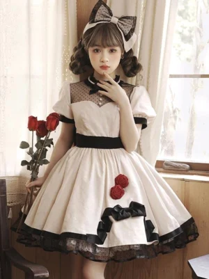 Sweet Lolita cotton jumper dress front view with beige base, black trims, red rose appliqués, tulle skirt hem, puff short sleeves, and black bow necktie perfect for tea parties and conventions