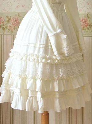 Cream colored ruffled sweet lolita skirt side profile showing elastic waist sleeve bow decoration and multi-layer ruffle construction