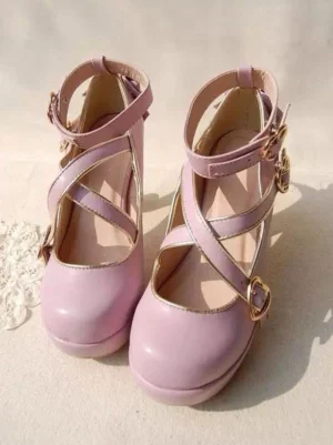 Pastel pink sweet lolita crisscross high heel pumps with heart-shaped gold buckles and ankle straps overhead view
