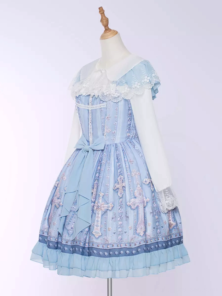 Sweet lolita cross print JSK dress detail shot showcasing fabric quality, ruffled construction, lace trim details, cross pattern print resolution, and garment construction craftsmanship studio photography