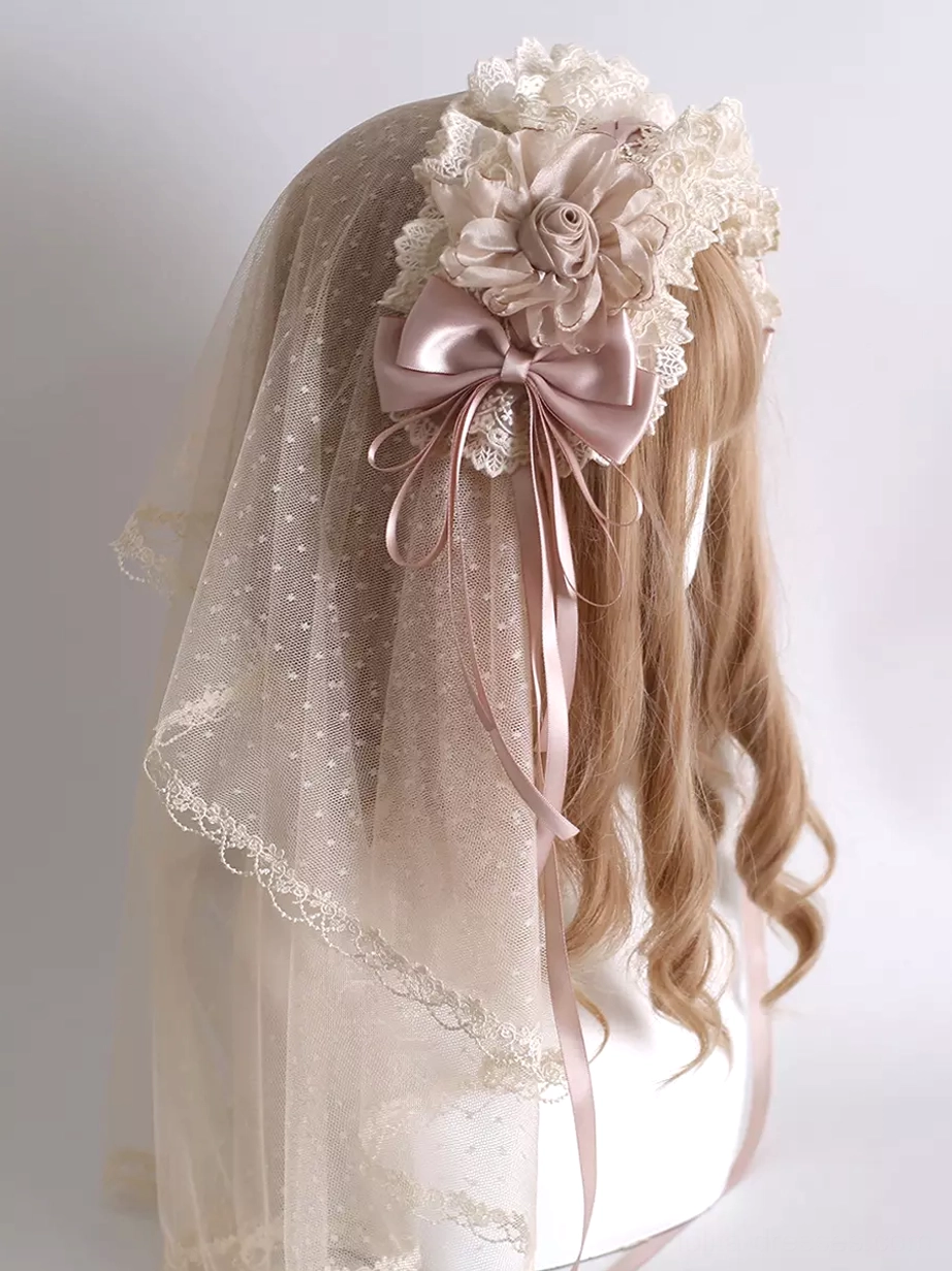 Sweet lolita dotted tulle floral hair veil with dusty pink satin bow and fabric flower accents, displayed on mannequin showing left front side view with lace trim details and delicate romantic aesthetic