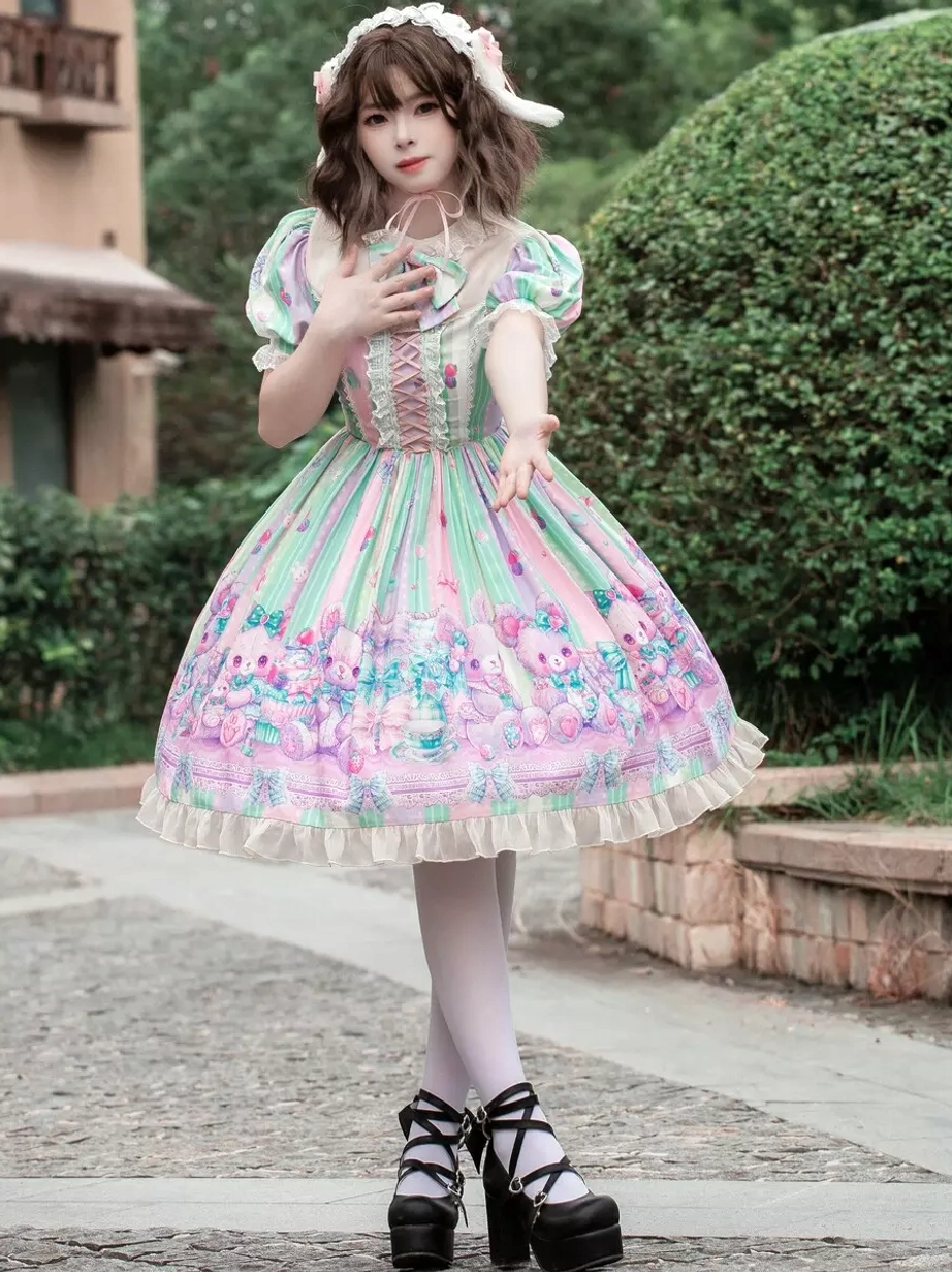 Sweet lolita dress side front three-quarter angle showcasing A-line flared skirt, pastel color scheme, lace-trimmed short ruffled sleeves, and lace details worn with bunny ear headband
