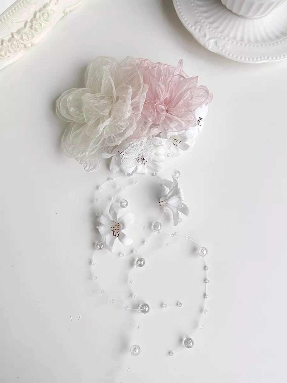 Lolita matching accessories set including organza flowers, pearl chain decorations, and floral brooches for sweet lolita dress styling shown in flat lay arrangement