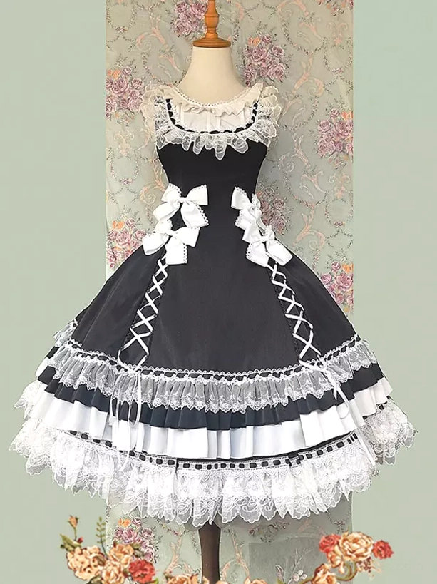 Black sleeveless sweet lolita jumper dress featuring side lace-up construction, layered lace-trimmed hem, and decorative waist bows on mannequin