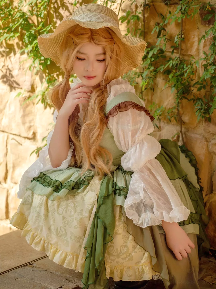 Close-up detail shot of sweet lolita dress bodice construction showing color-block pattern and decorative embellishments
