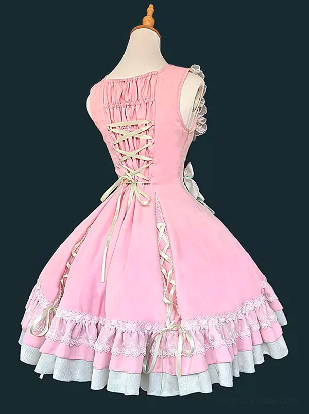 Sweet lolita sleeveless dress showing construction details with lace embellishments, multi-layer ruffled hem, and structural bow elements on dress form