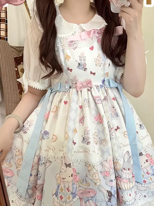 Close-up front detail shot of sweet lolita jumper dress with peter pan collar pink front bow cartoon dessert print
