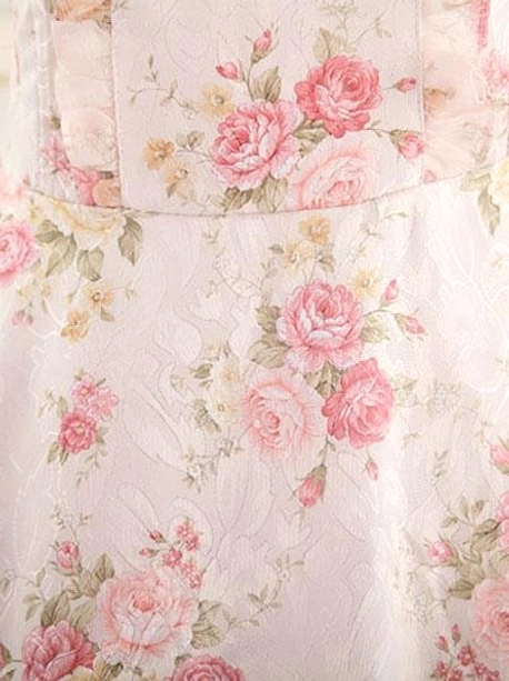 Lolita dress fabric close-up flat lay showing pink rose floral print texture, delicate flower motifs, woven fabric quality, printed pattern detail on base material
