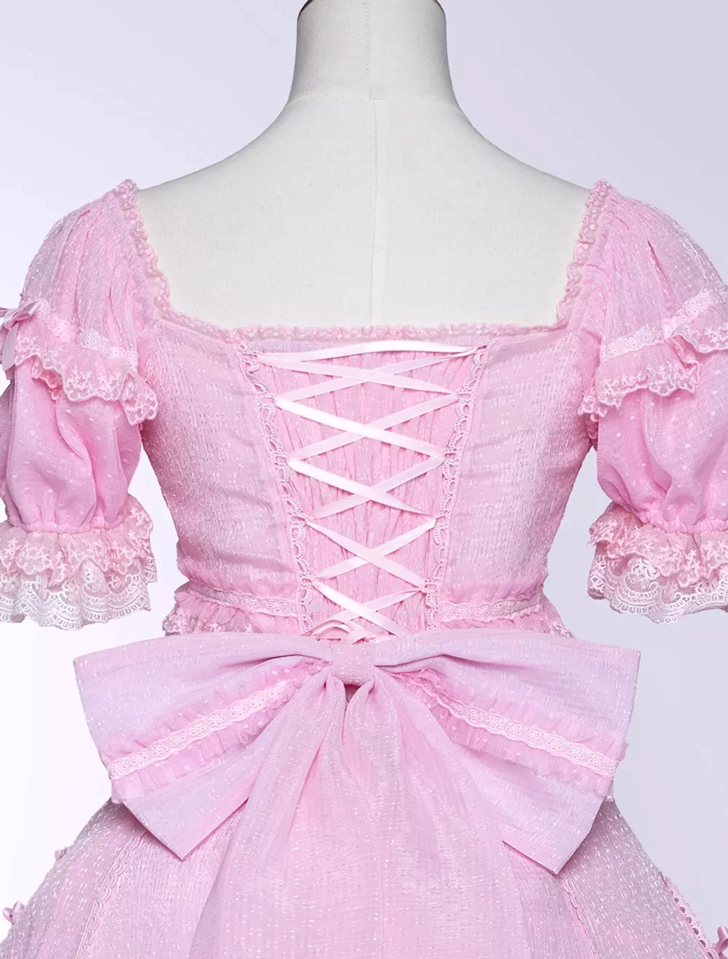 Sweet Lolita dress fabric texture detail showing layered lace ruffles polyester material quality
