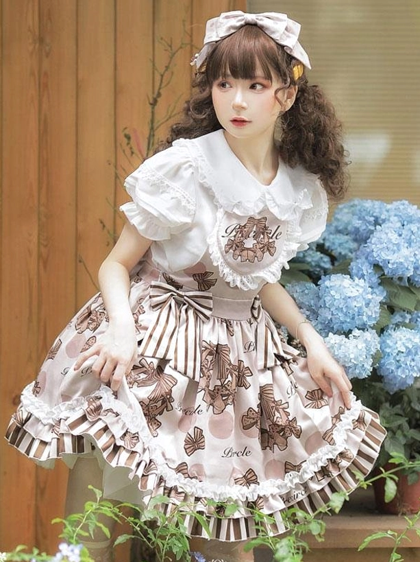 Sweet lolita dress set front right three-quarter view with hand on skirt waist showing lace-trimmed neckline against wooden wall background