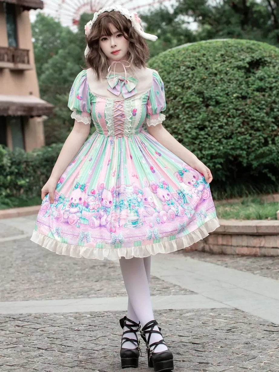 Sweet lolita dress side front three-quarter view with hands-on-skirt pose highlighting full A-line skirt volume, cartoon hem print, ruffled details, and elegant silhouette