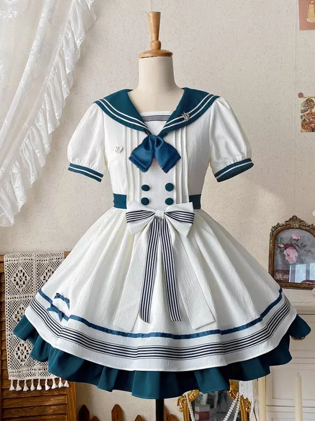 White navy sailor sweet lolita dress front full view on dress form display with front bow button decorations and striped skirt