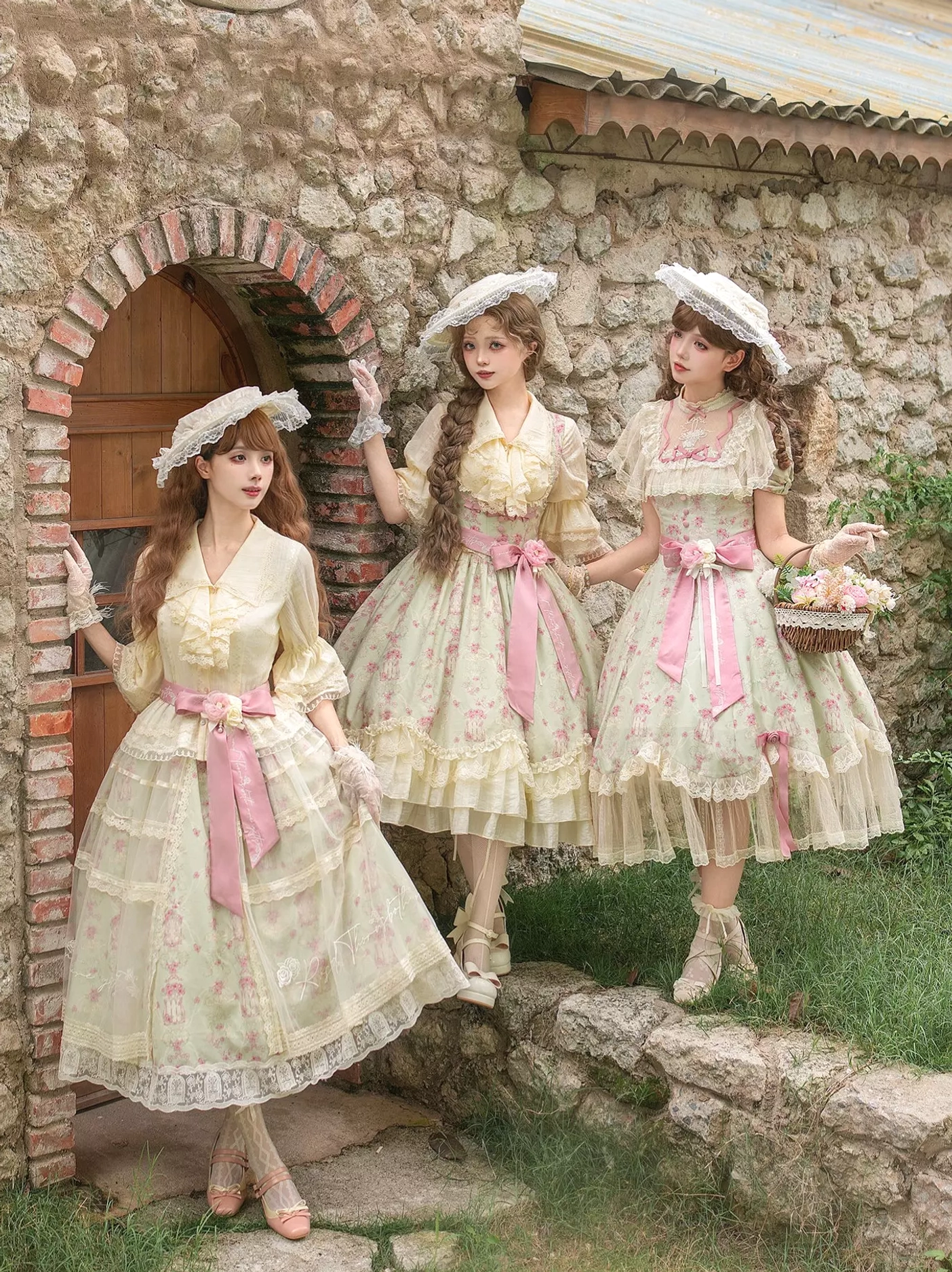 Group lolita models three wearing matching sweet lolita dresses cream pink floral outdoor courtyard straw hats