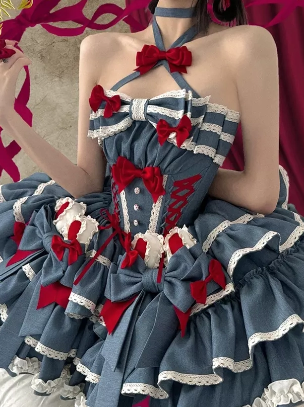 Sweet lolita dress close-up front upper body showing cross halter straps red bow accents and ruffled skirt layers