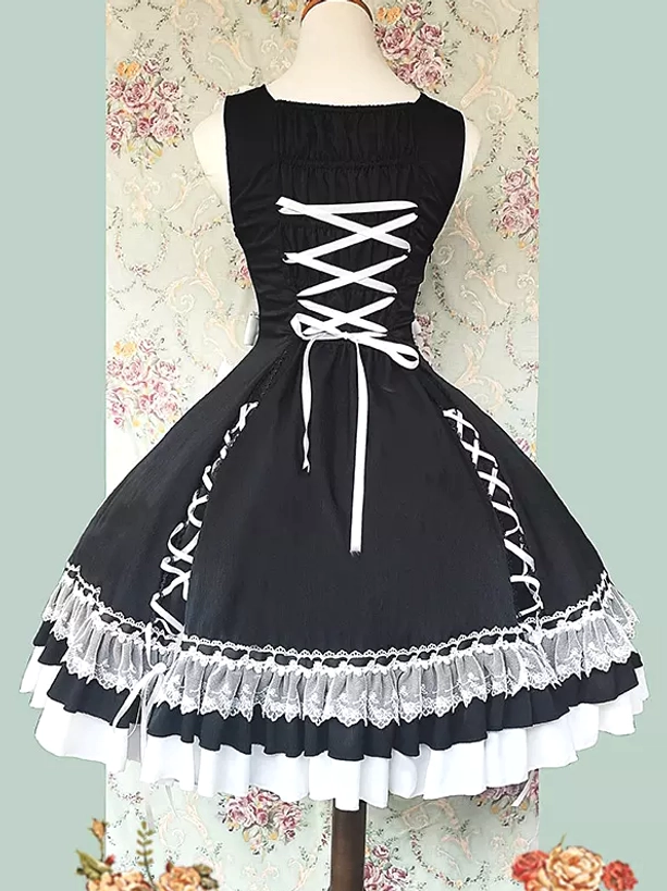 Sweet lolita sleeveless dress detail shot showing lace embellishments, bow decorations, and ruffled hem construction, close-up view of design elements