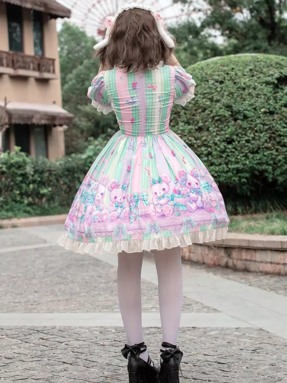 Sweet lolita dress full back view displaying lace-up back bodice construction, matching vertical stripe print throughout, ruffled dress hem, and rear silhouette with bunny hair accessory