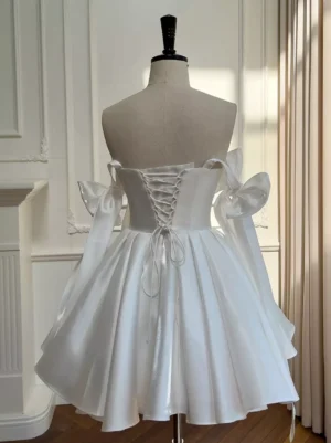 Lace-up corset back detail of white sweet lolita dress, showing crisscross lacing closure and bow-adorned shoulder straps