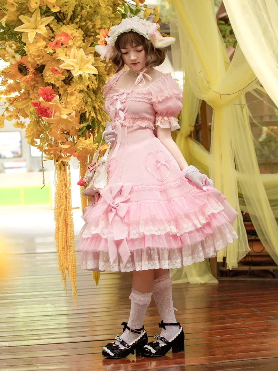Sweet Lolita dress left side full-body view showing fitted waist ruffled cuffs and coordinated handbag