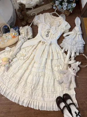 Light apricot lolita dress flat lay overhead view showing full ensemble with matching accessories, Mary Jane shoes, and coordinating ornaments on wooden surface