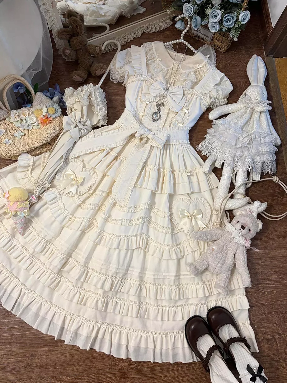 Light apricot lolita dress flat lay overhead view showing full ensemble with matching accessories, Mary Jane shoes, and coordinating ornaments on wooden surface