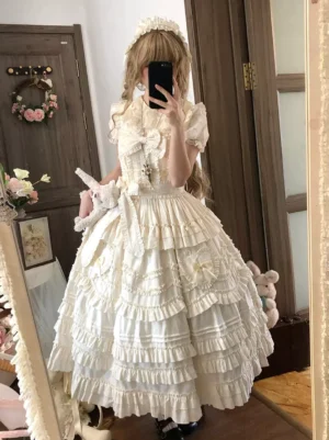 Light apricot sweet lolita sleeveless dress with multi-tiered ruffles and decorative bows worn by blonde model in indoor home setting