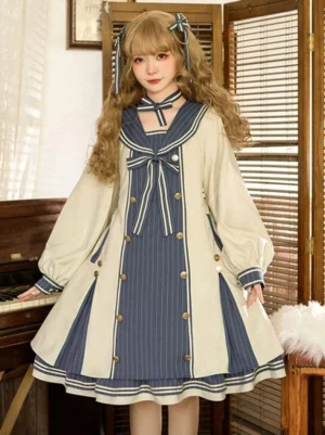 Three-quarter front angle of sweet lolita dress featuring gold double-breasted buttons, long voluminous puff sleeves, sailor collar, and cream base with navy accents on elegant blonde model