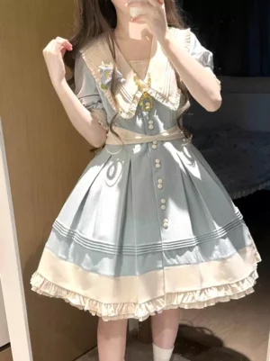 Sweet lolita dress with light sky blue and ivory colors, front mirror selfie view showing Peter Pan collar, short puff sleeves, front button placket, tiered ruffle hemline, and waist bow embellishment