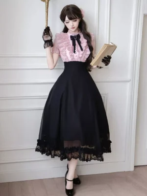 Pink and black two-tone sweet lolita dress with short puff sleeves, black bow collar, and layered lace hem, displayed on model in elegant indoor setting